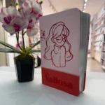 Biblia Valiosa rosada exhibida de pie junto a una orquídea en una librería cristiana – imagen 2